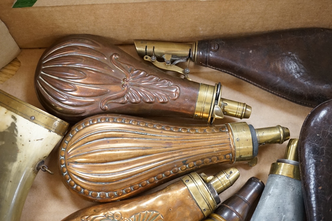Nine powder flasks and shot flasks, all 19th century, comprising of two horn flasks, one flattened with brass mounts, three shot bags with sprung brass chargers, three copper gun flasks and another of zinc